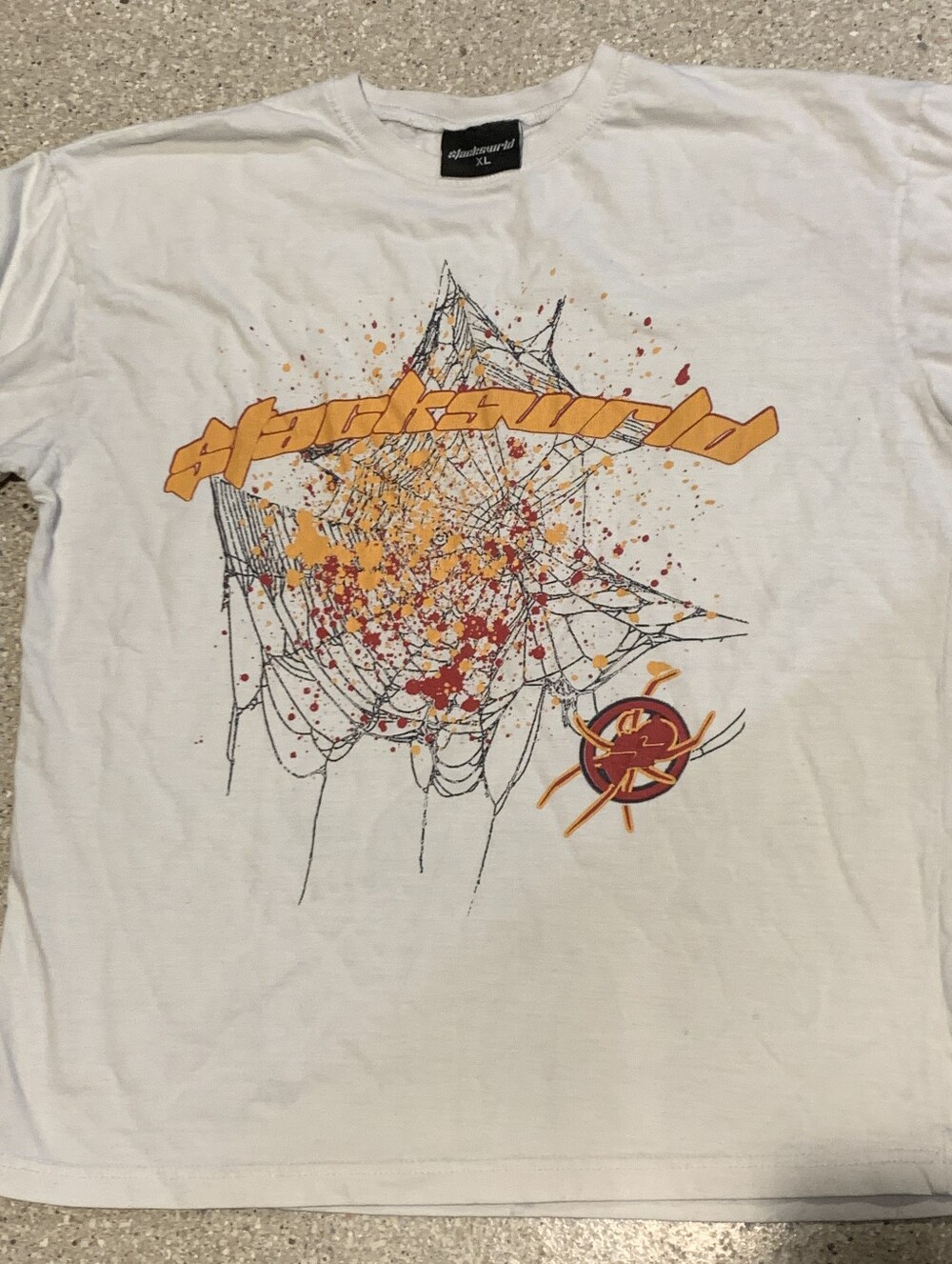 #721 "Slackswrld" White Graphic Spiderweb Tee with Yellow & Red Print